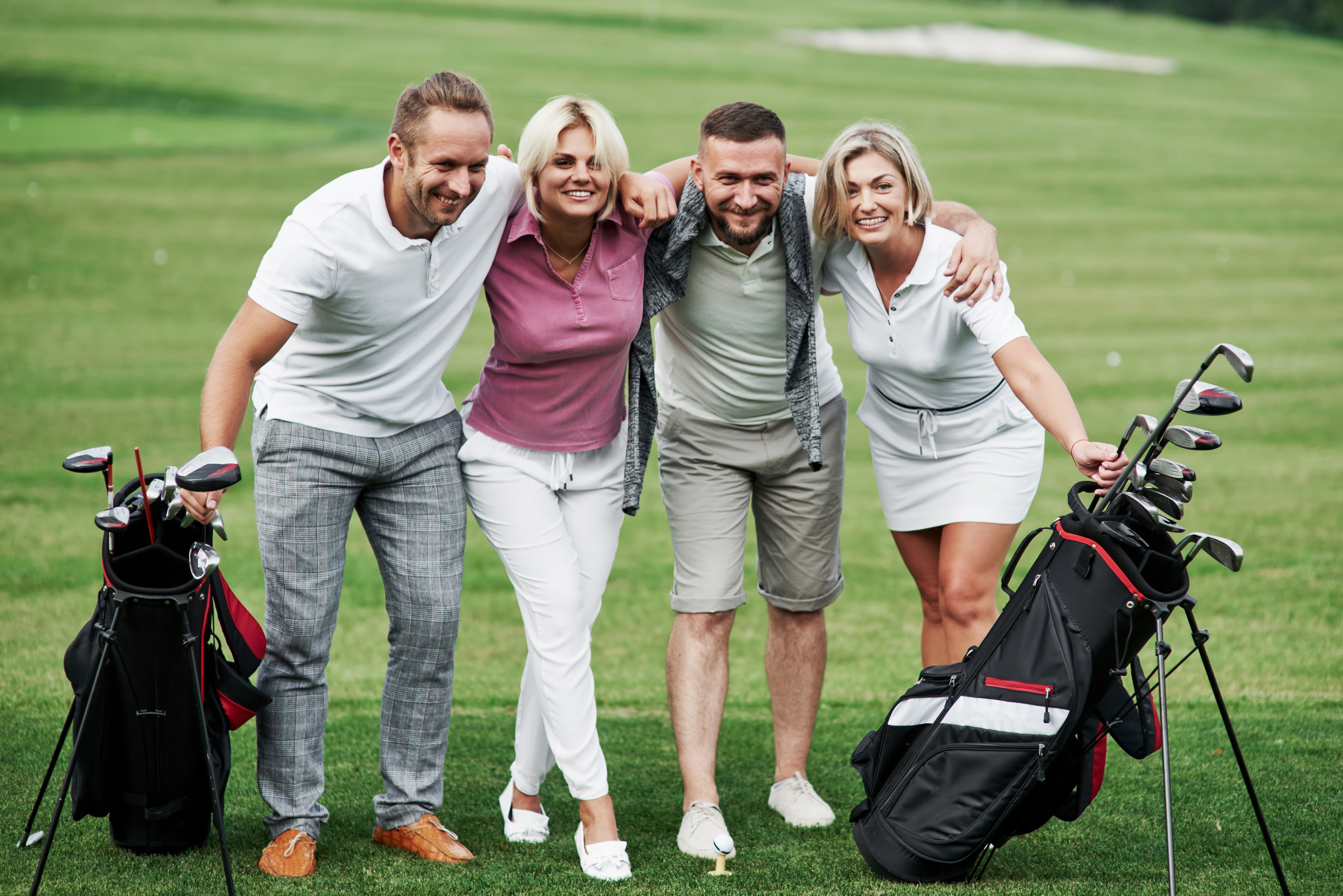 Four golfers posing together on the course